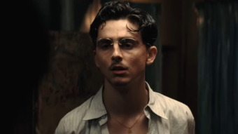 Timothée Chalamet moustache fine et lunettes rondes dans le film Marty Supreme réalisé par Josh Safdie.